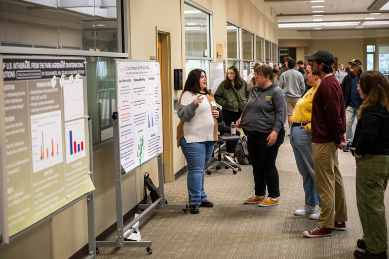 2025 FYS Poster Session presenter with audience